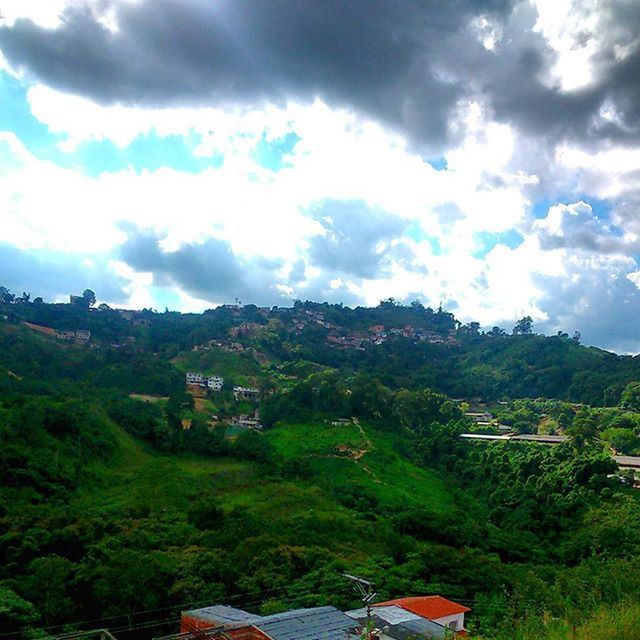 SCENIC VIEW OF MOUNTAINS AGAINST CLOUDY SKY