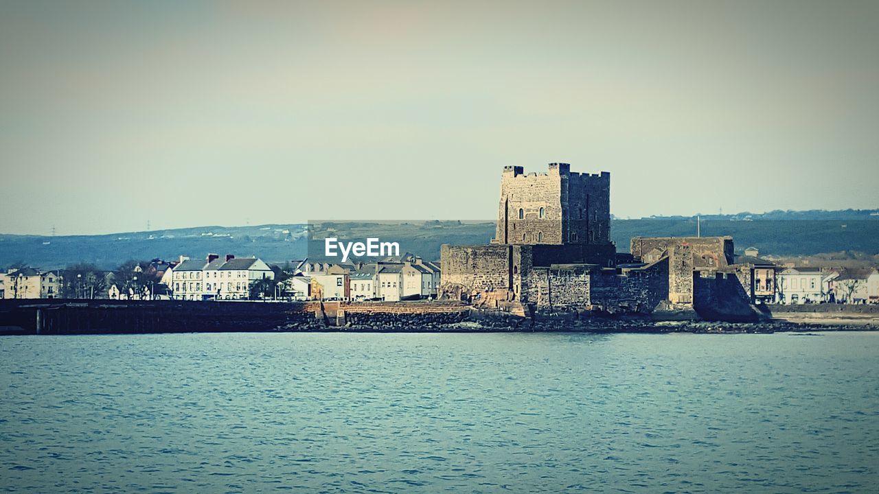 VIEW OF SEA WITH BUILDINGS IN BACKGROUND