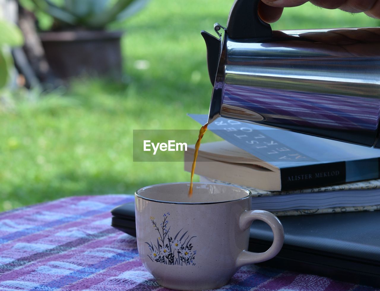 CLOSE-UP OF COFFEE CUP IN GLASS