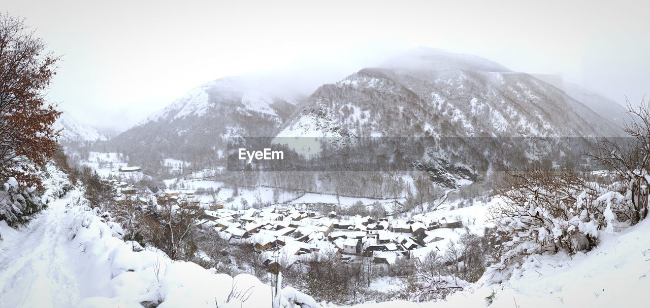 SNOW COVERED LANDSCAPE AGAINST SKY