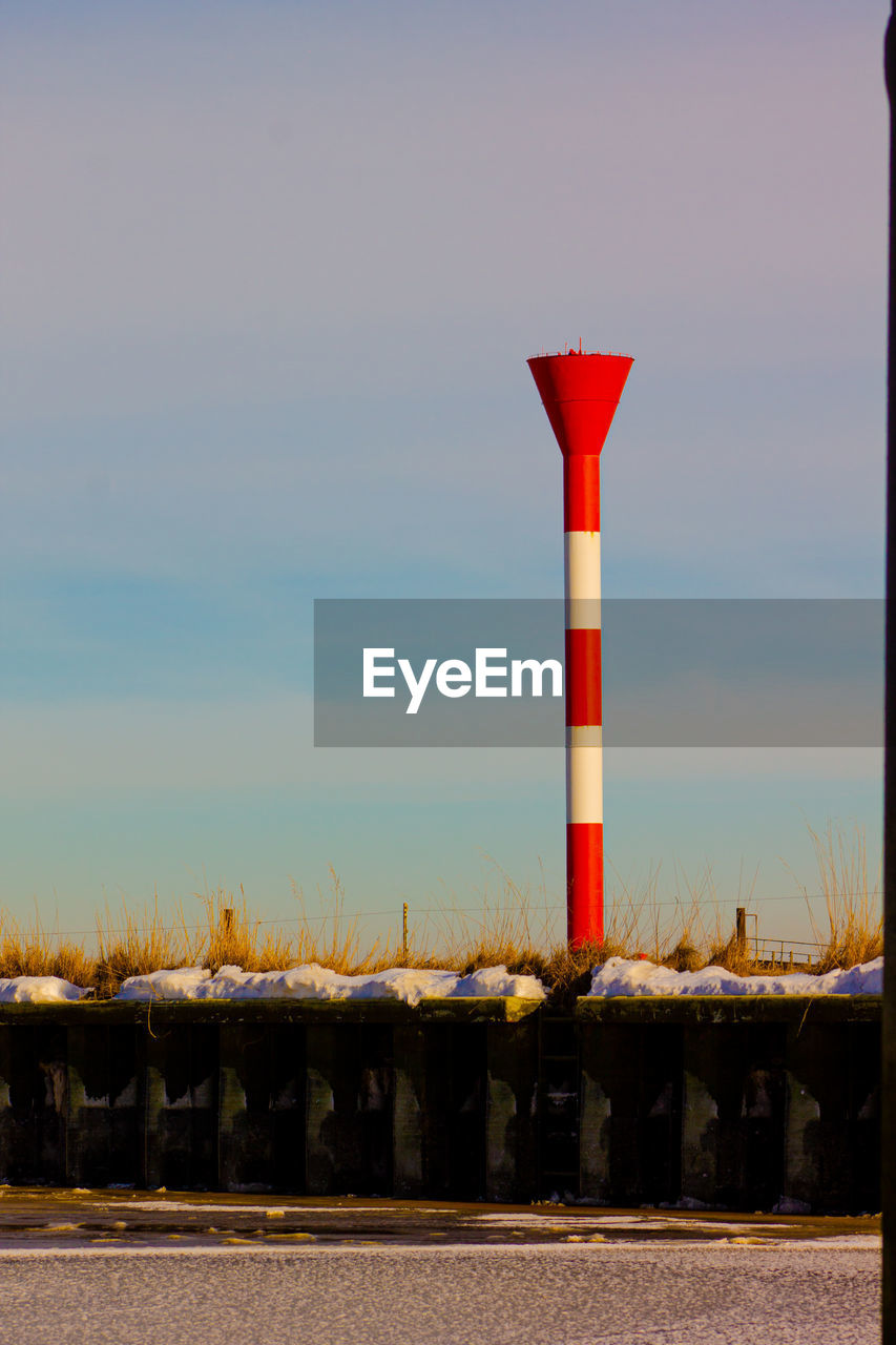 Red lighthouse against sky