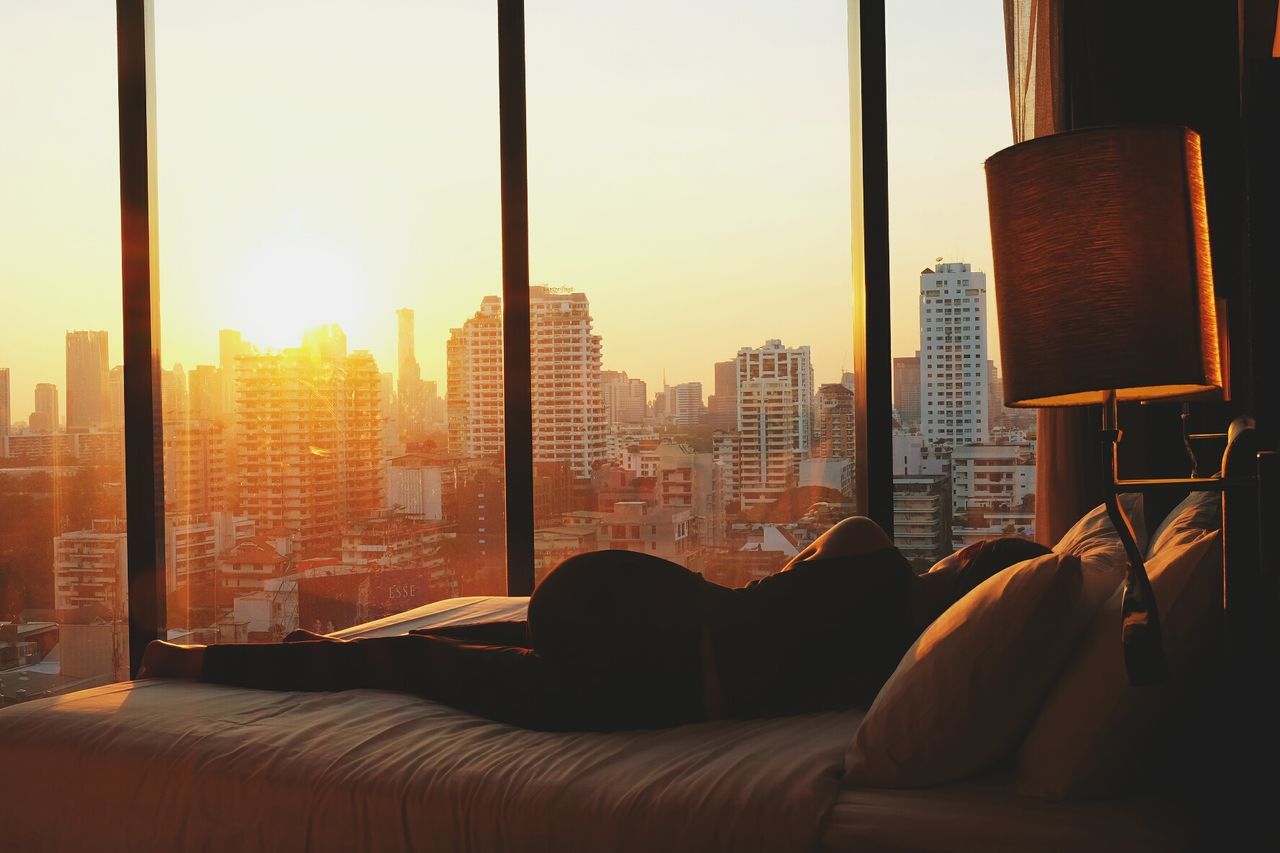 Woman resting on side in bedroom