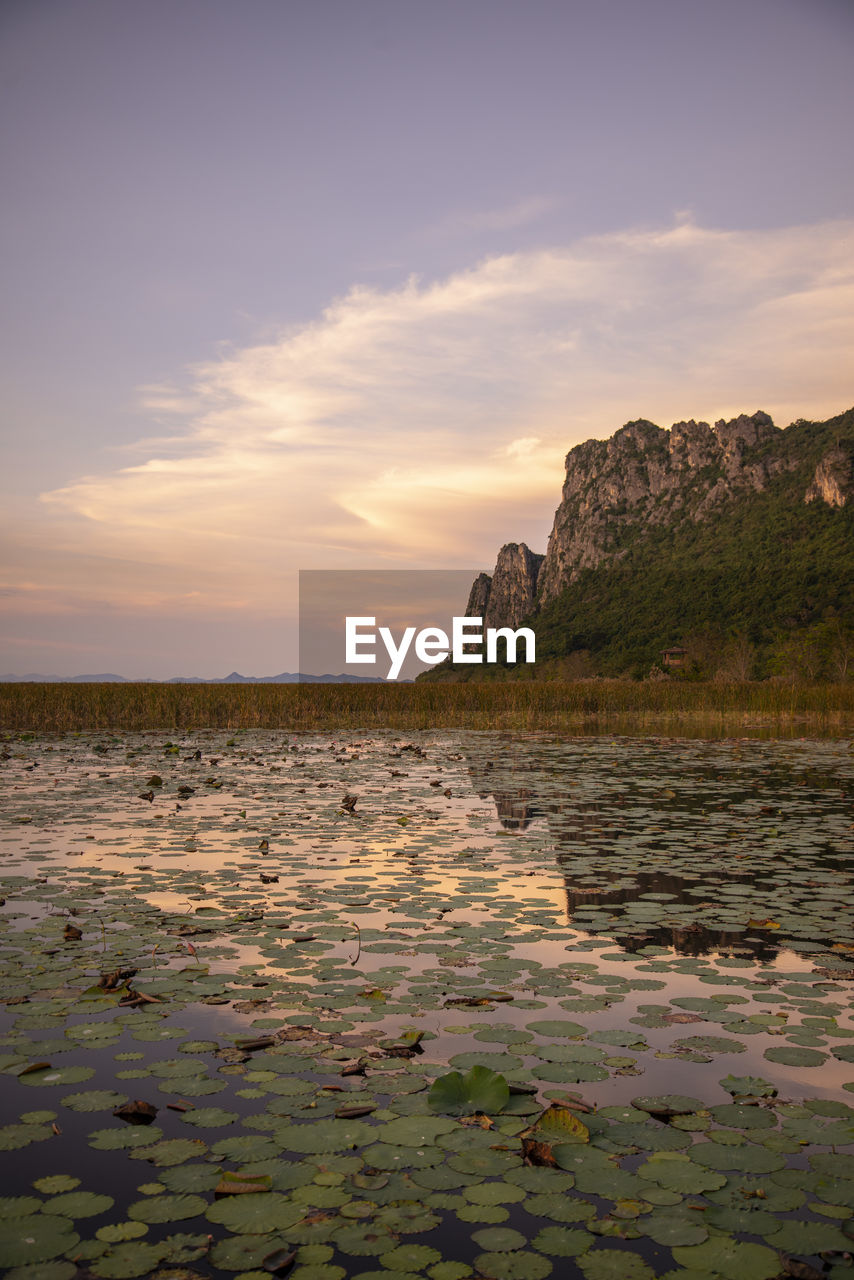 scenic view of lake against sky during sunset