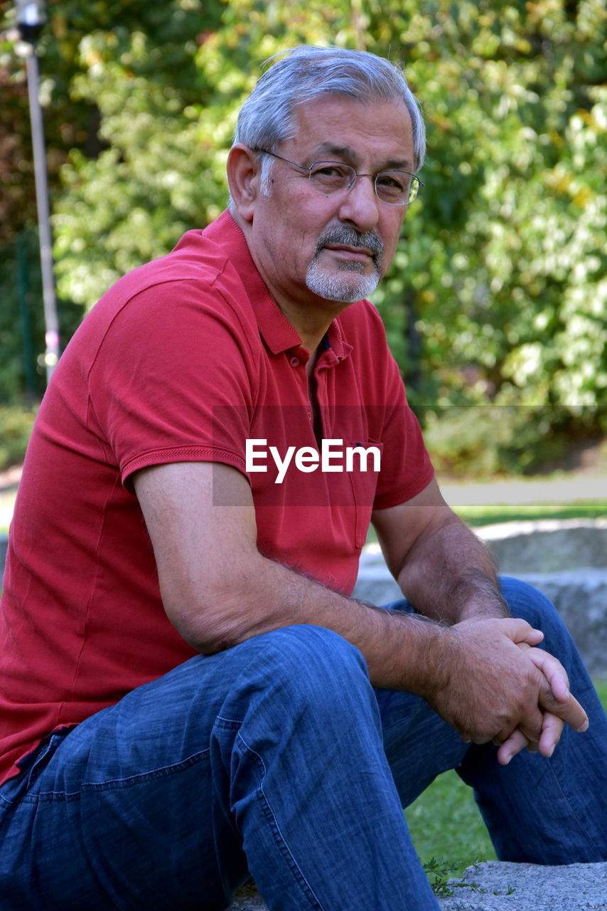 Portrait of man sitting in park