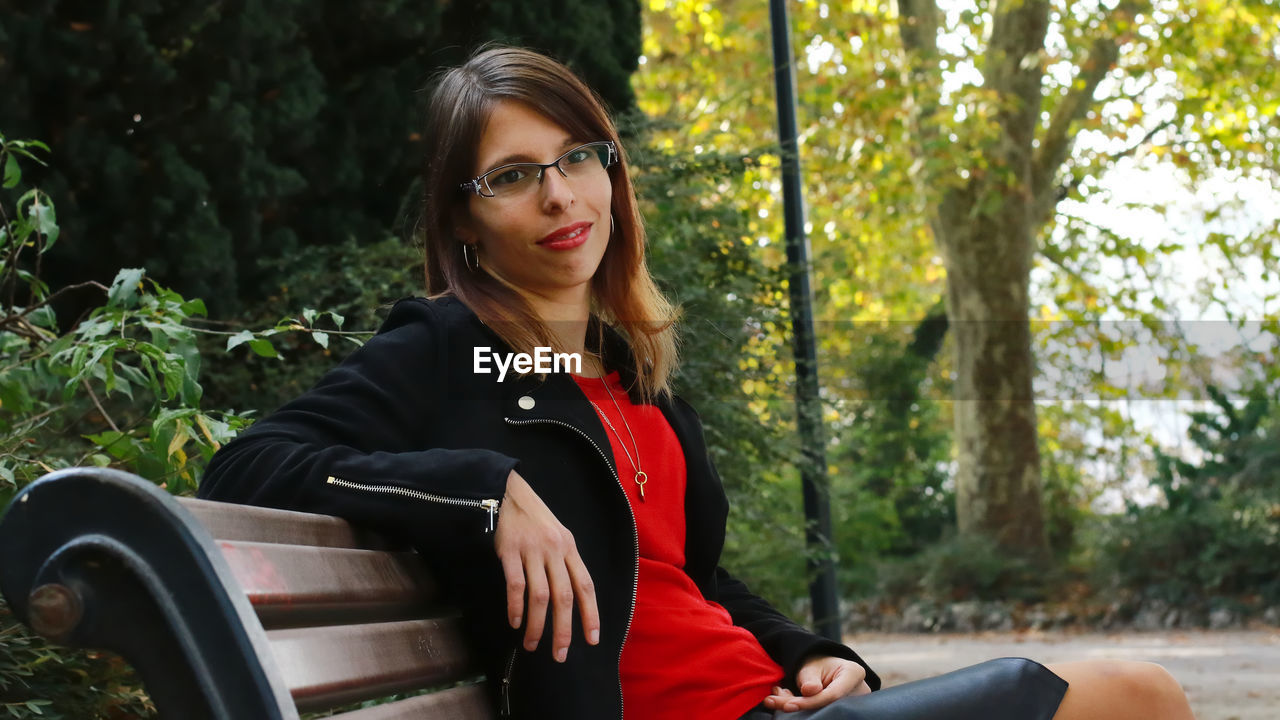 Portrait of woman sitting in park