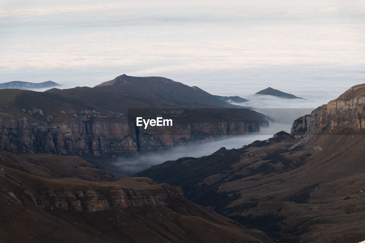 environment, mountain, landscape, scenics - nature, beauty in nature, nature, land, wilderness, sky, travel destinations, travel, mountain range, cloud, no people, rock, fog, outdoors, plateau, water, non-urban scene, valley, tourism, geology, tranquility, ridge, terrain, tranquil scene, day