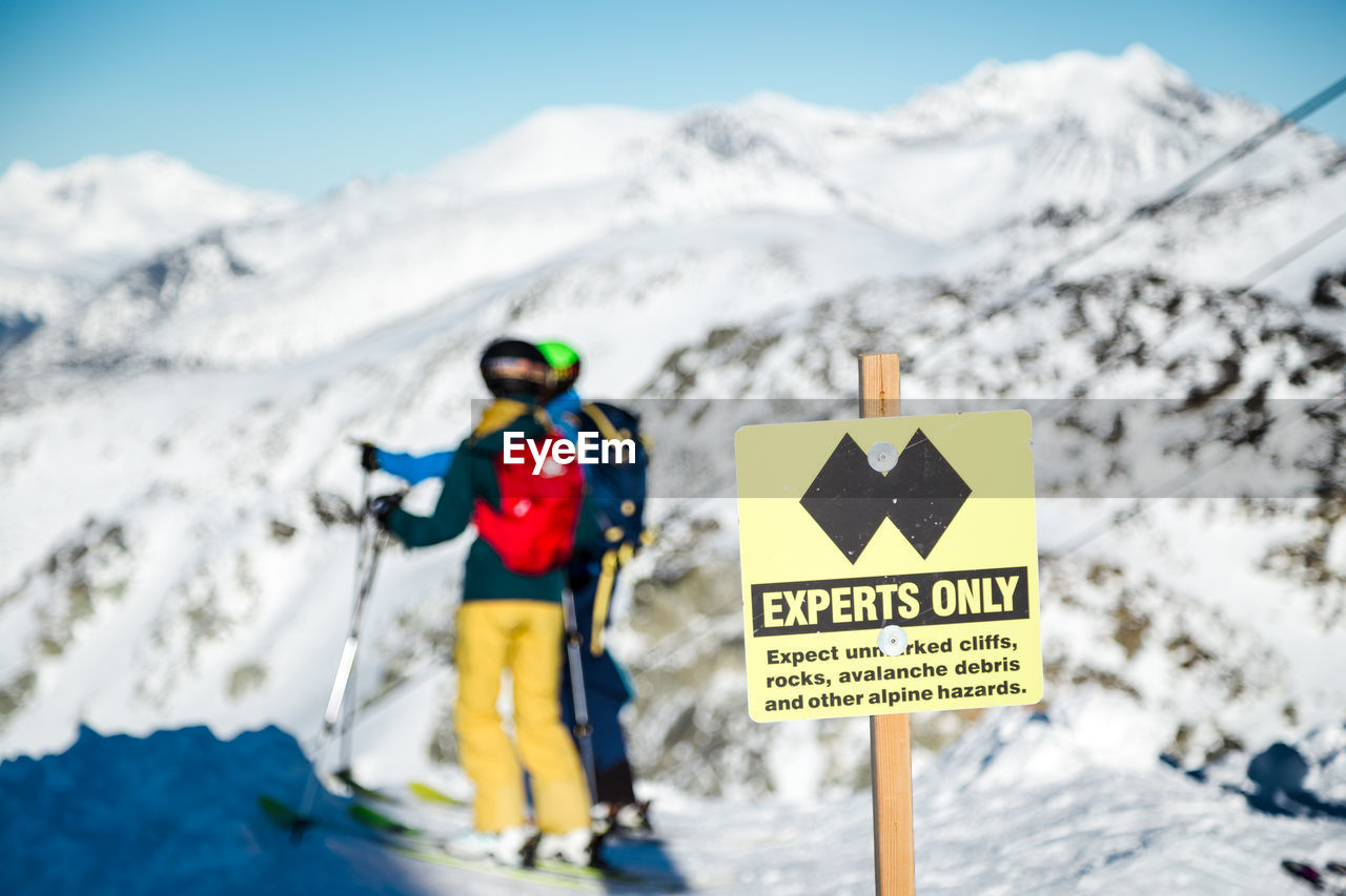 INFORMATION SIGN ON SNOWCAPPED MOUNTAINS