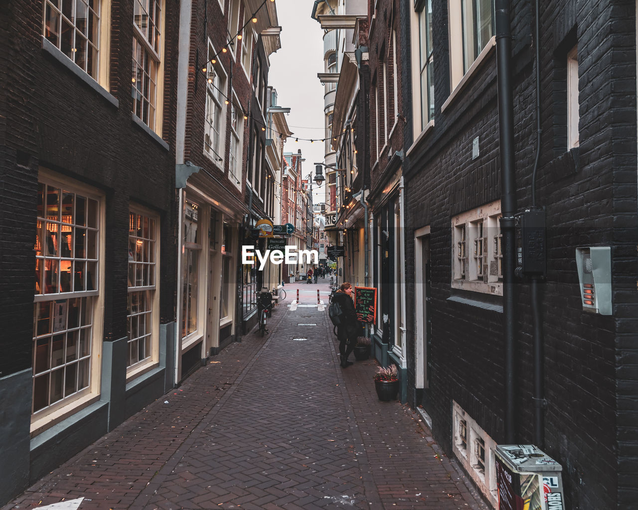 Narrow street amidst buildings in city