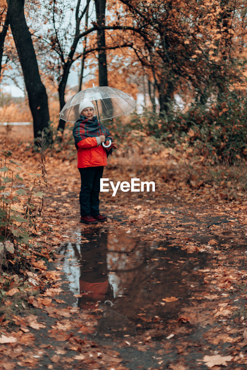 Full length of woman walking in forest