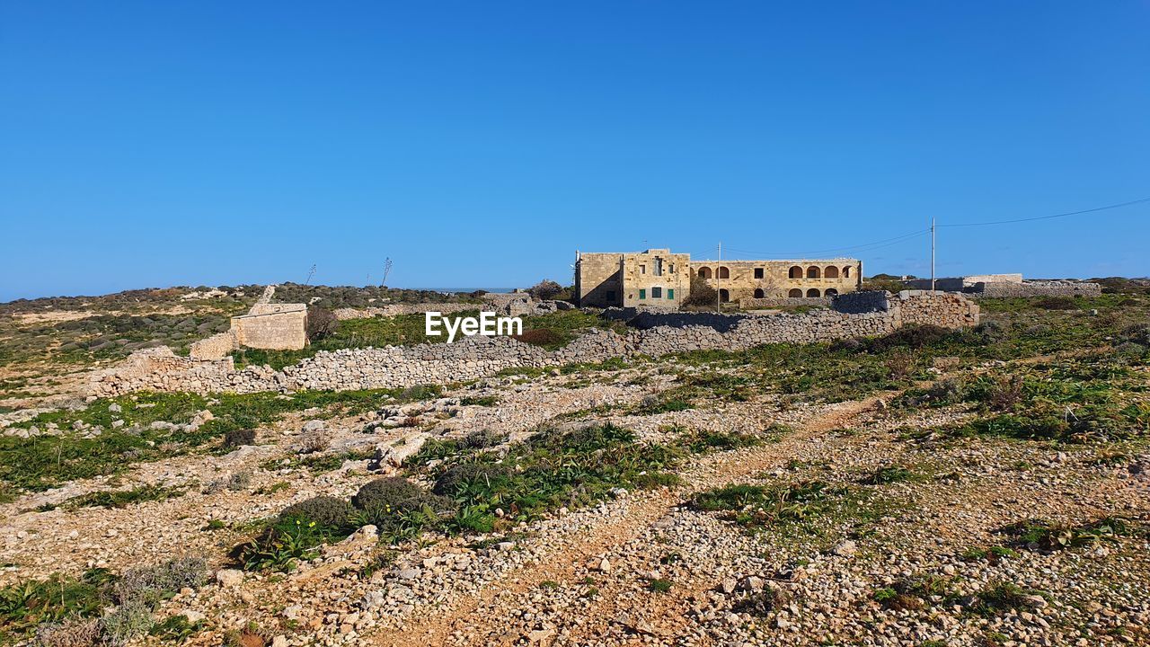 View of old building against clear blue sky