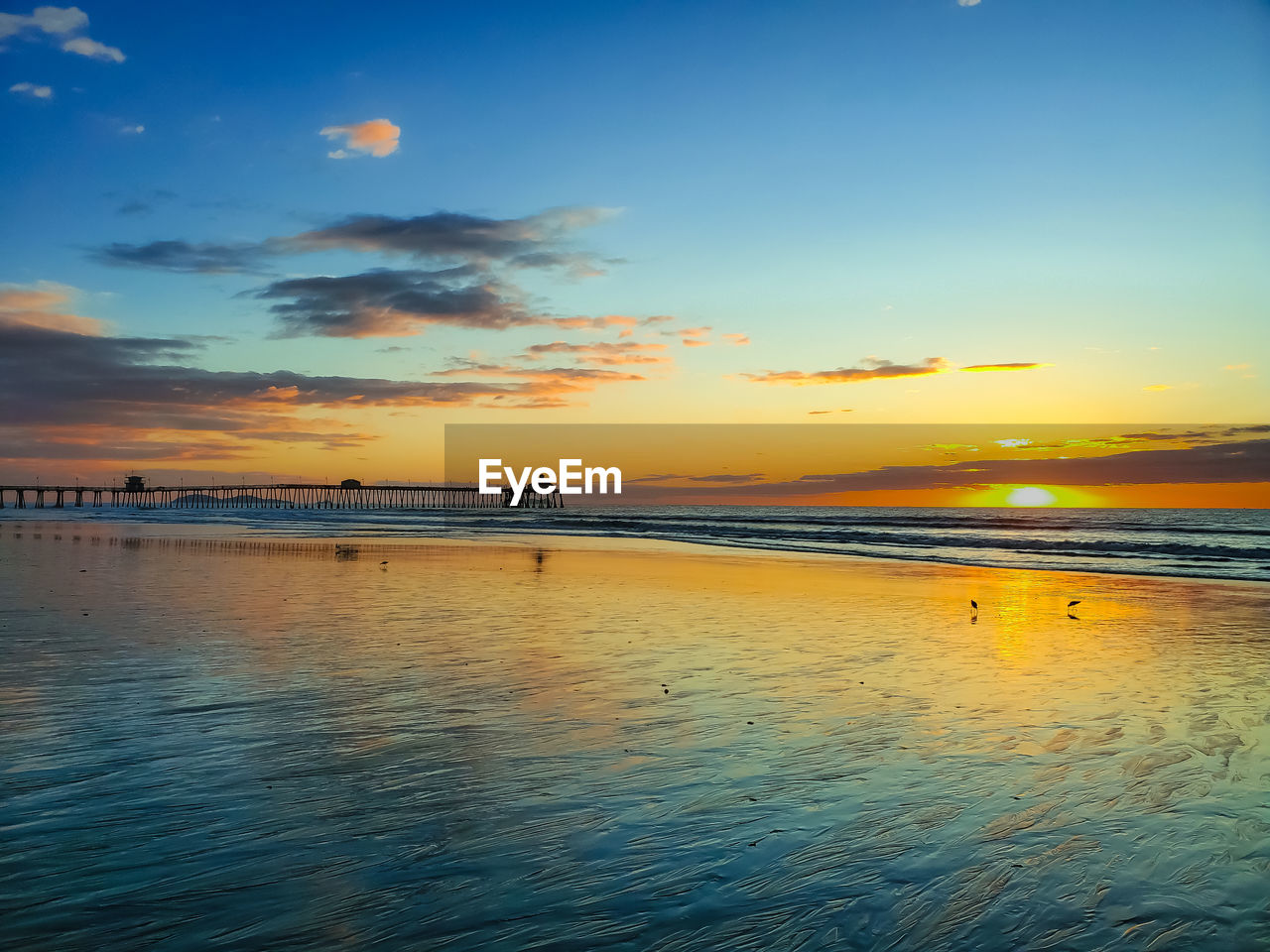 SCENIC VIEW OF BEACH DURING SUNSET