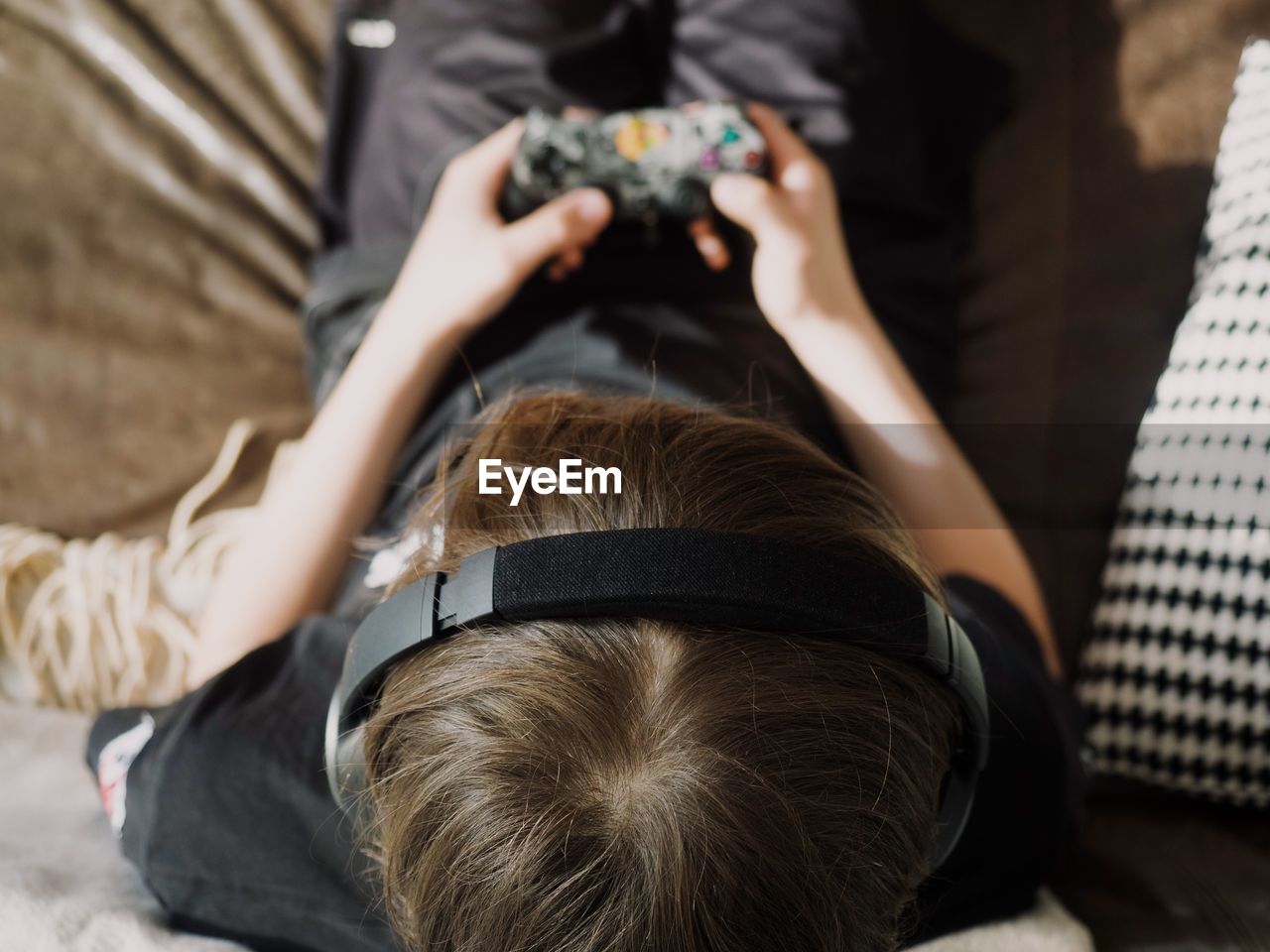 Boy playing video game at home