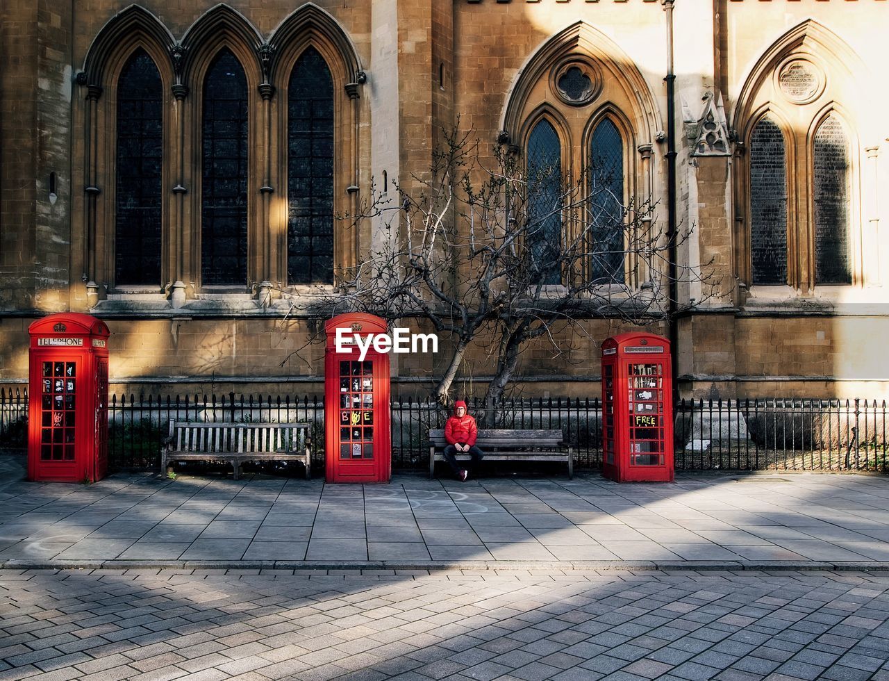 Man sitting on bench in city