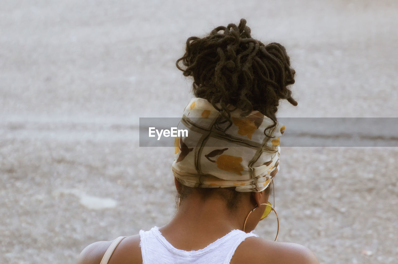 Rear view of woman wearing headscarf on street