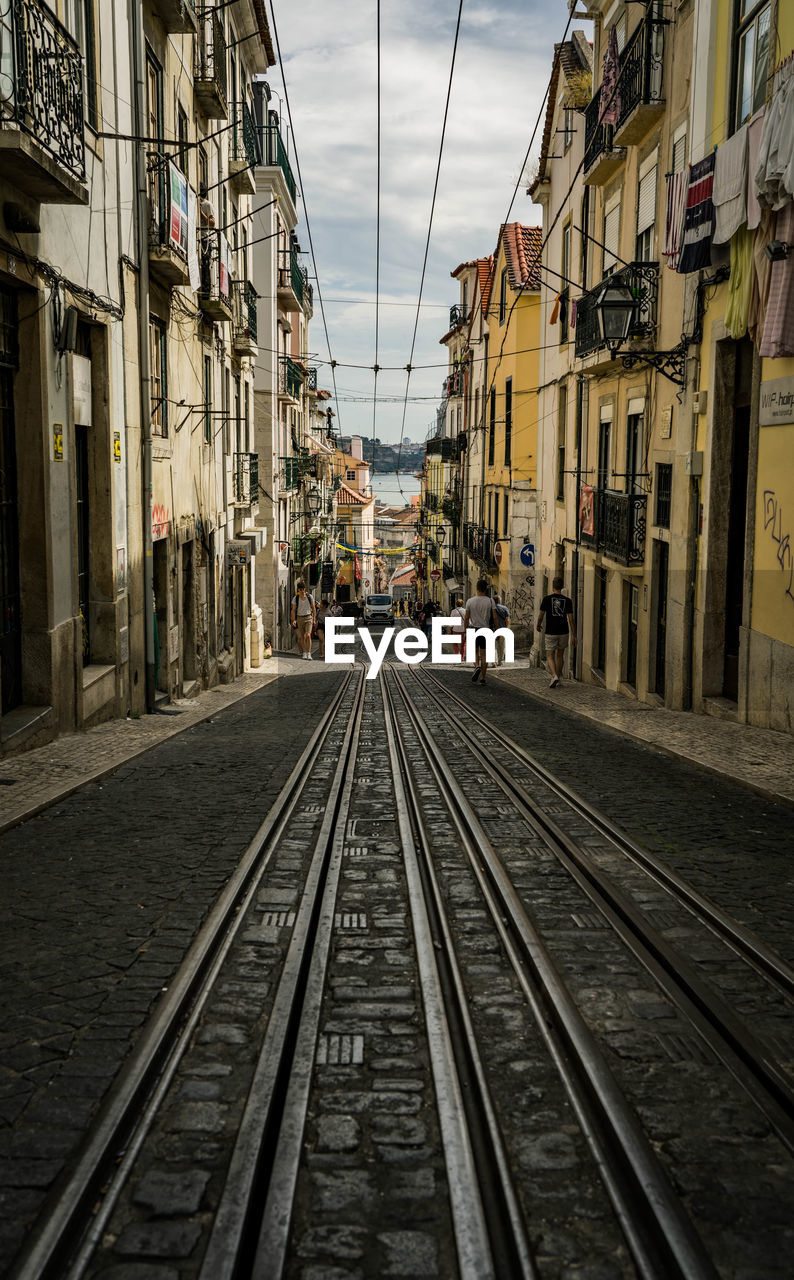 Tramway amidst buildings in city