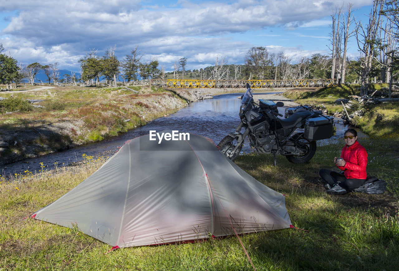 Portrait of woman camping next to ruta j, tierra del fuego