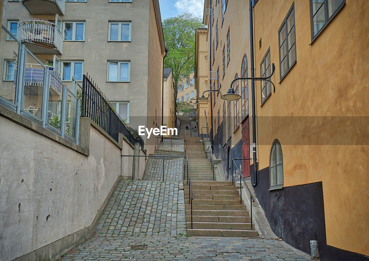 Low angle view of staircase amidst buildings in city