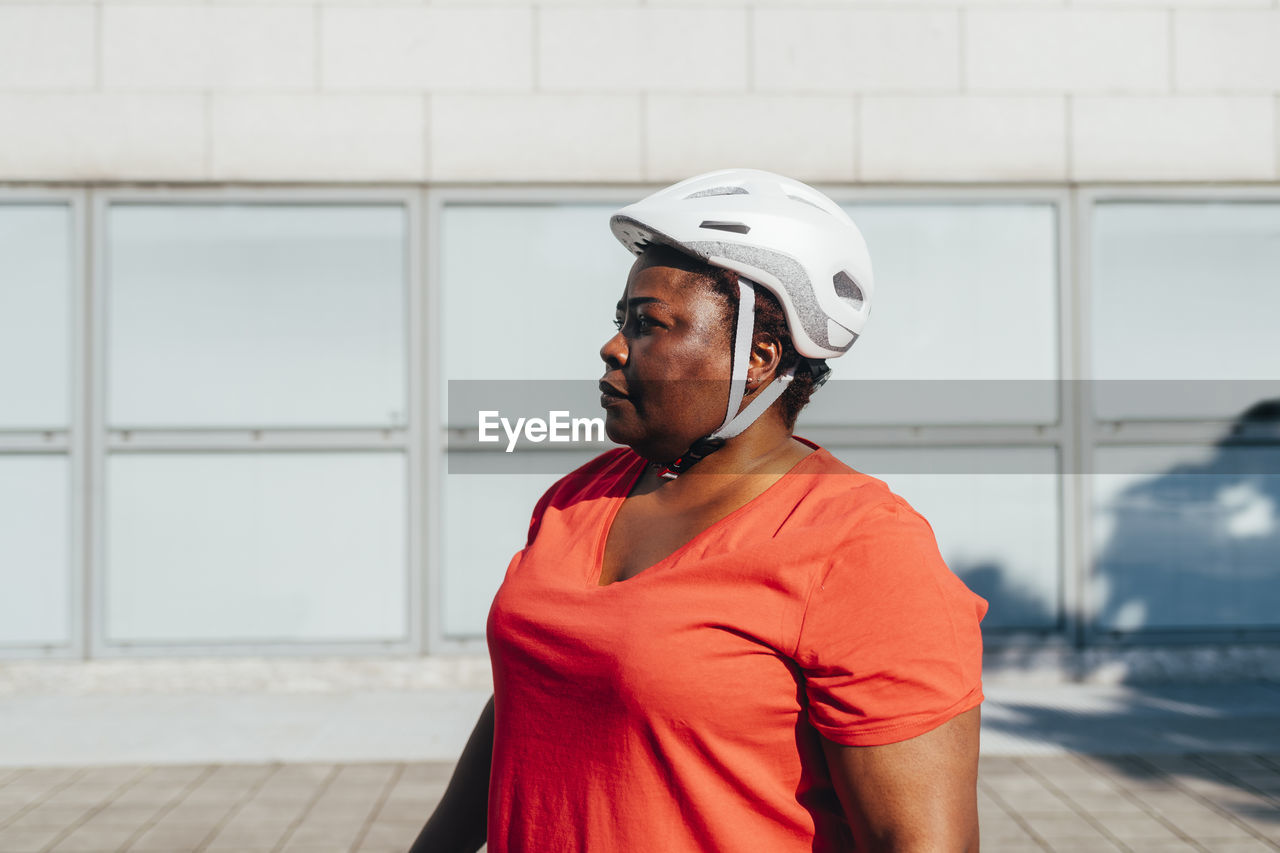 Woman wearing cycling helmet on sunny day