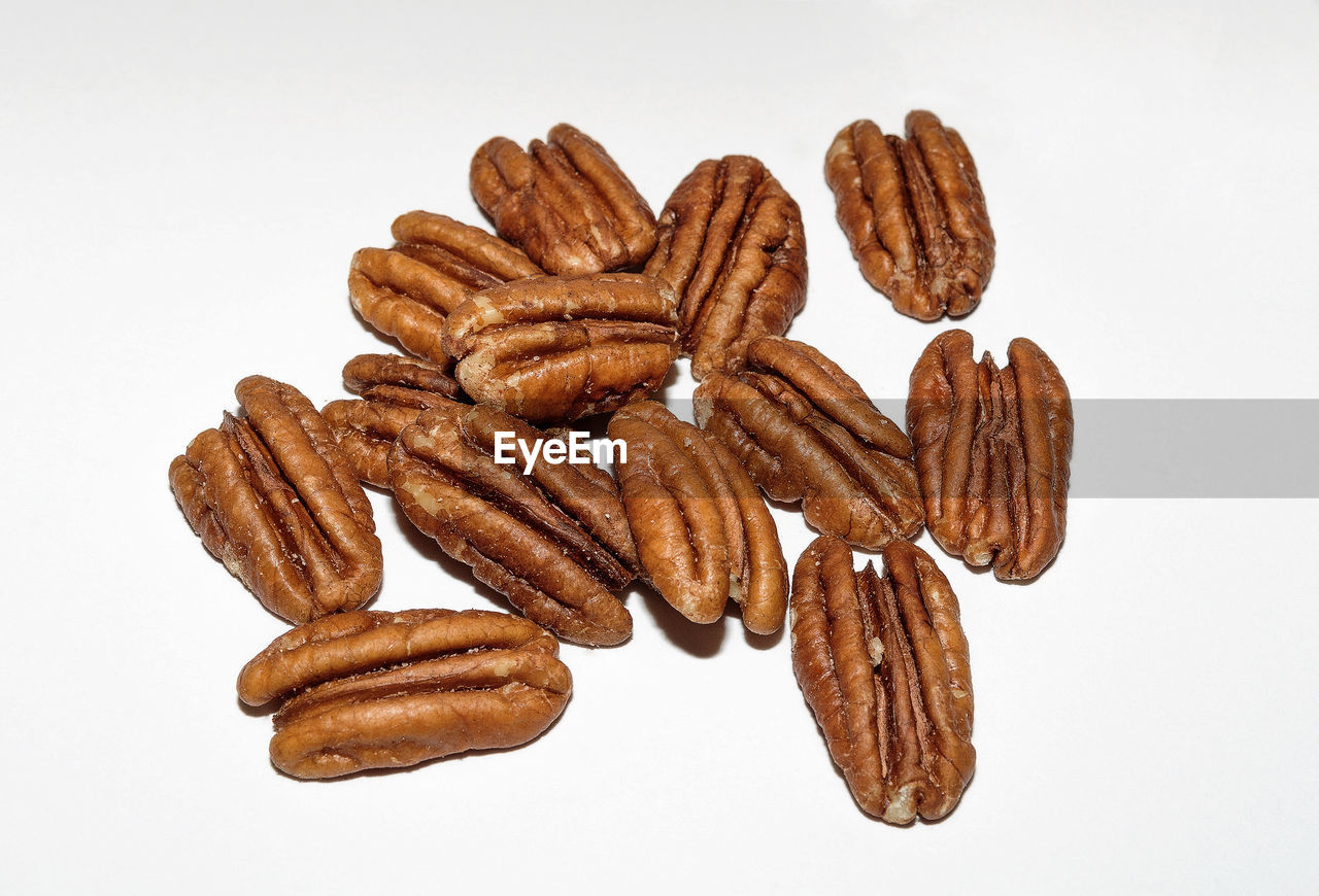 Close-up of walnuts over white background