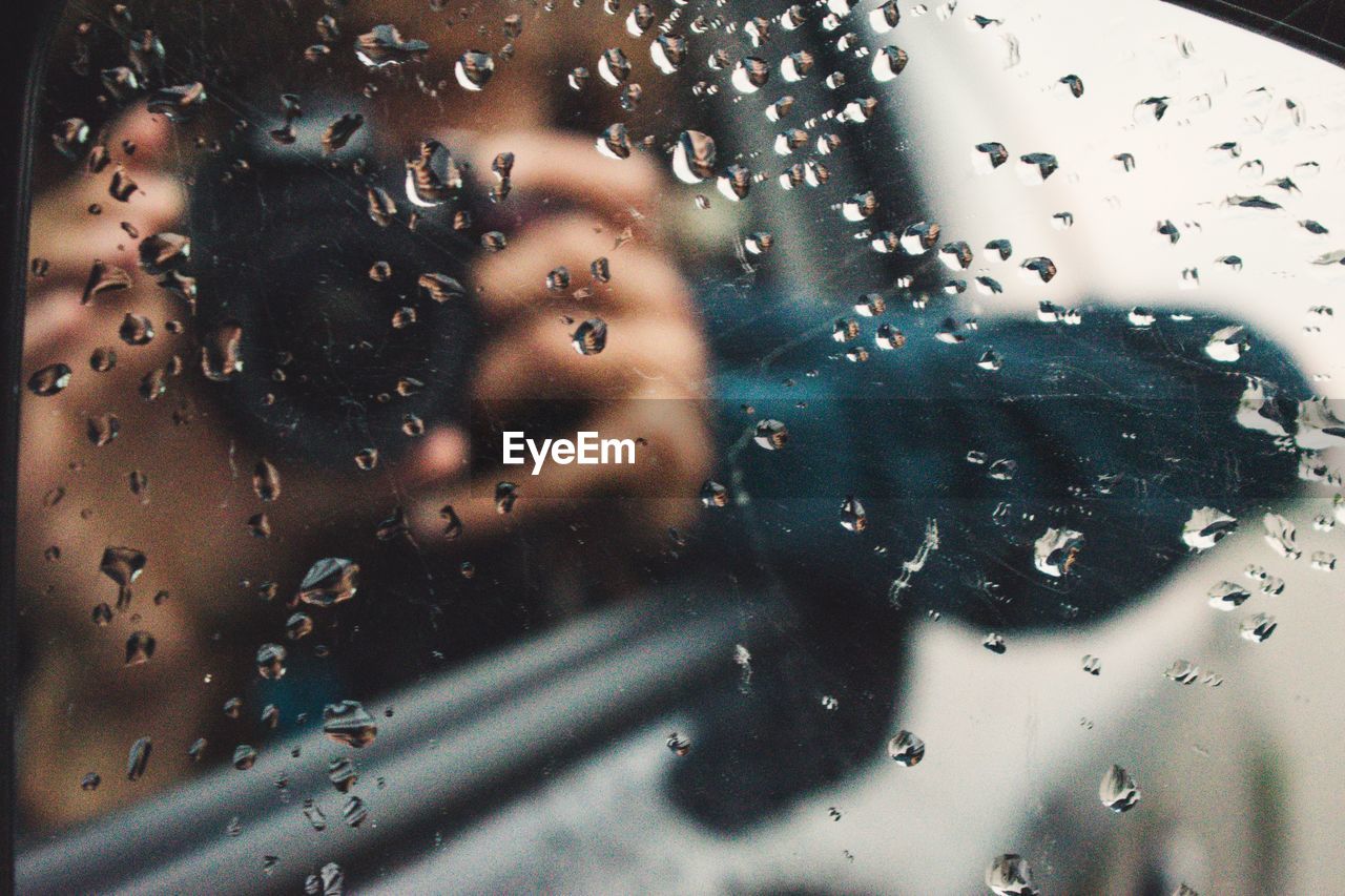 FULL FRAME SHOT OF WATER DROPS ON CAR WINDOW