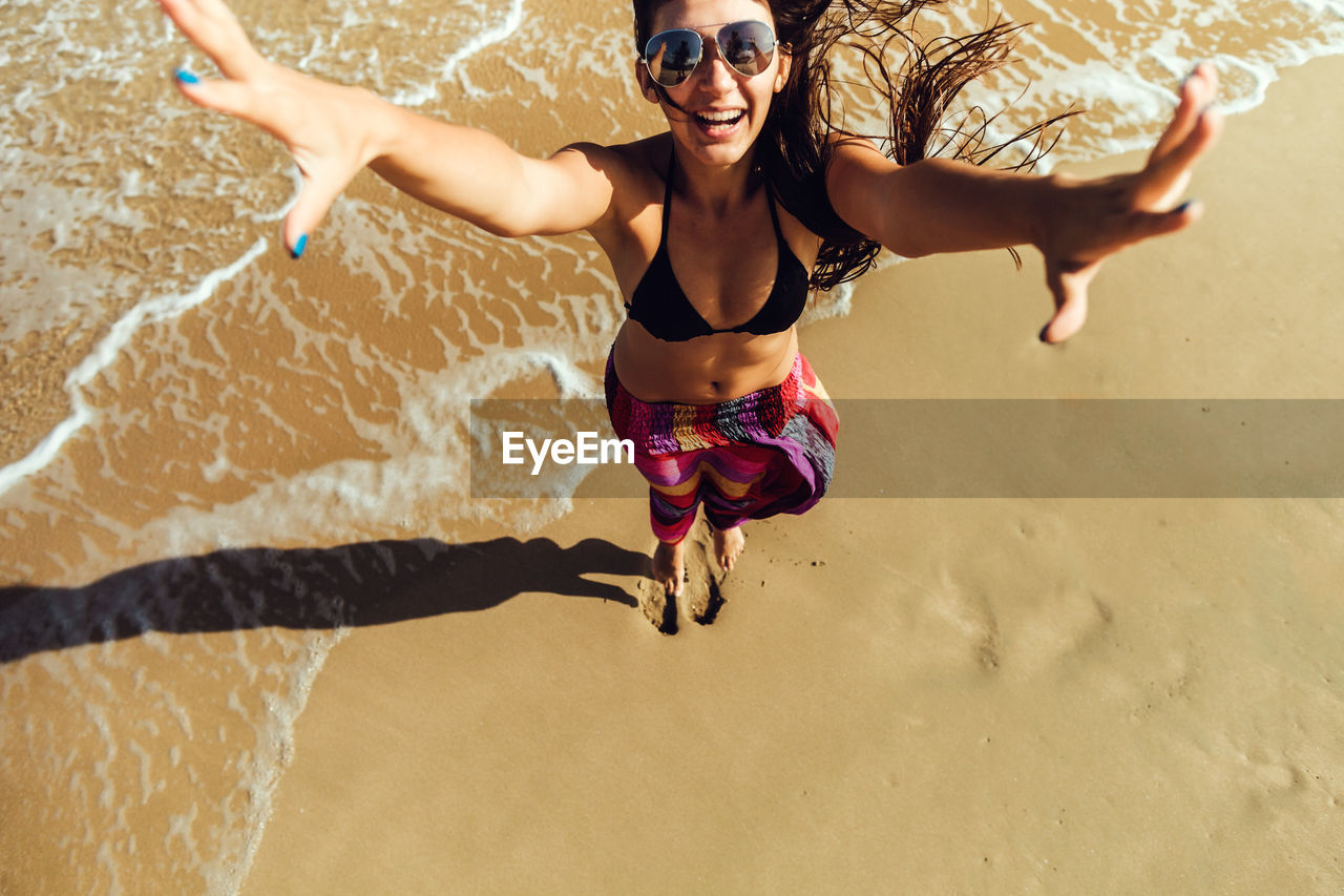 Young woman wearing sunglasses on beach