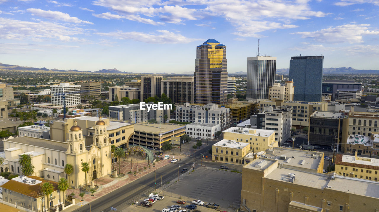 HIGH ANGLE VIEW OF MODERN BUILDINGS IN CITY AGAINST SKY