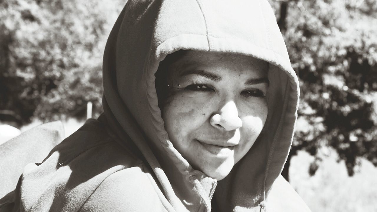 Close-up portrait of mid adult woman in hooded jacket