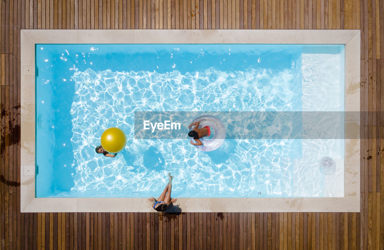 Mother having fun with kids in pool