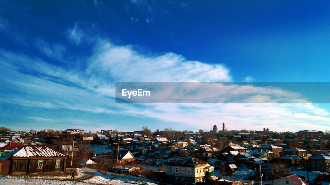 Cityscape against cloudy sky