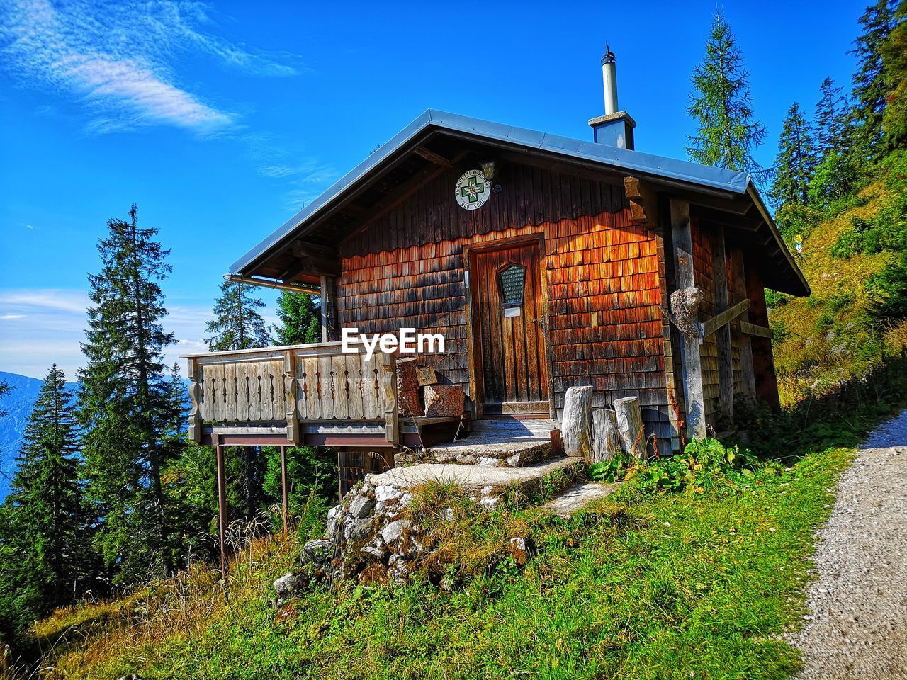 OLD WOODEN HOUSE ON FIELD