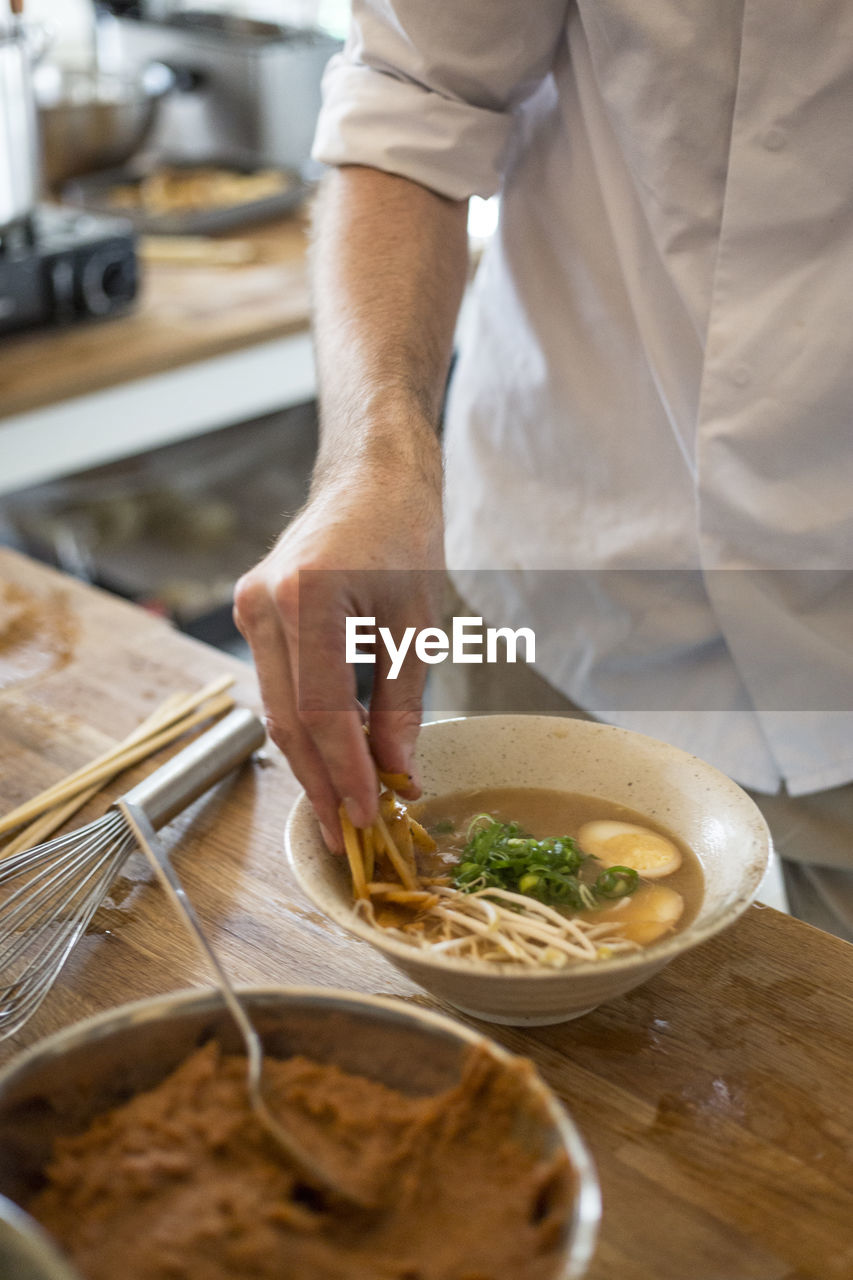 Midsection of man preparing food