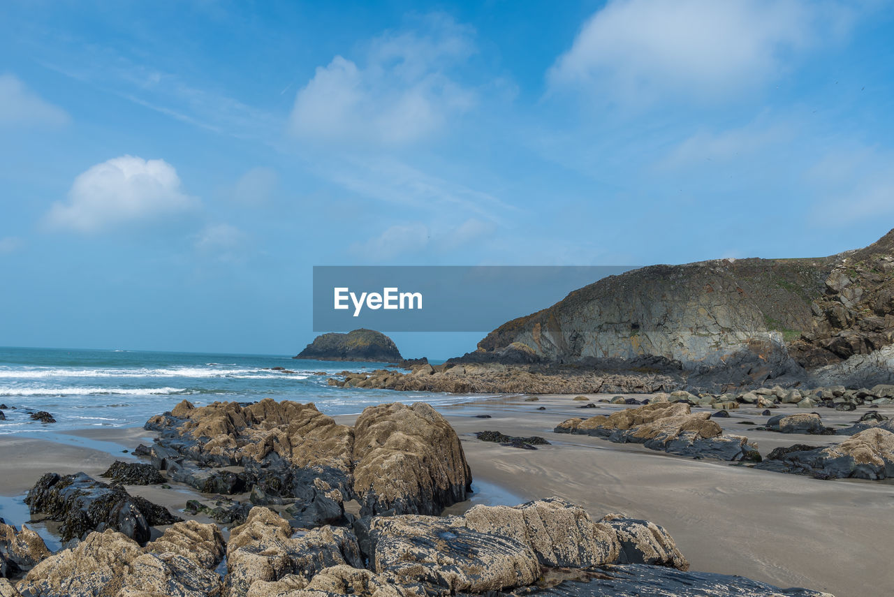 Rocks on beach against sky