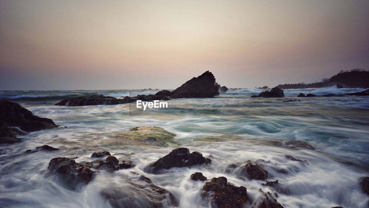 Scenic view of sea against clear sky during sunset