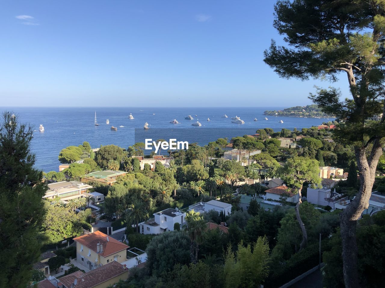 High angle view of buildings by sea against sky