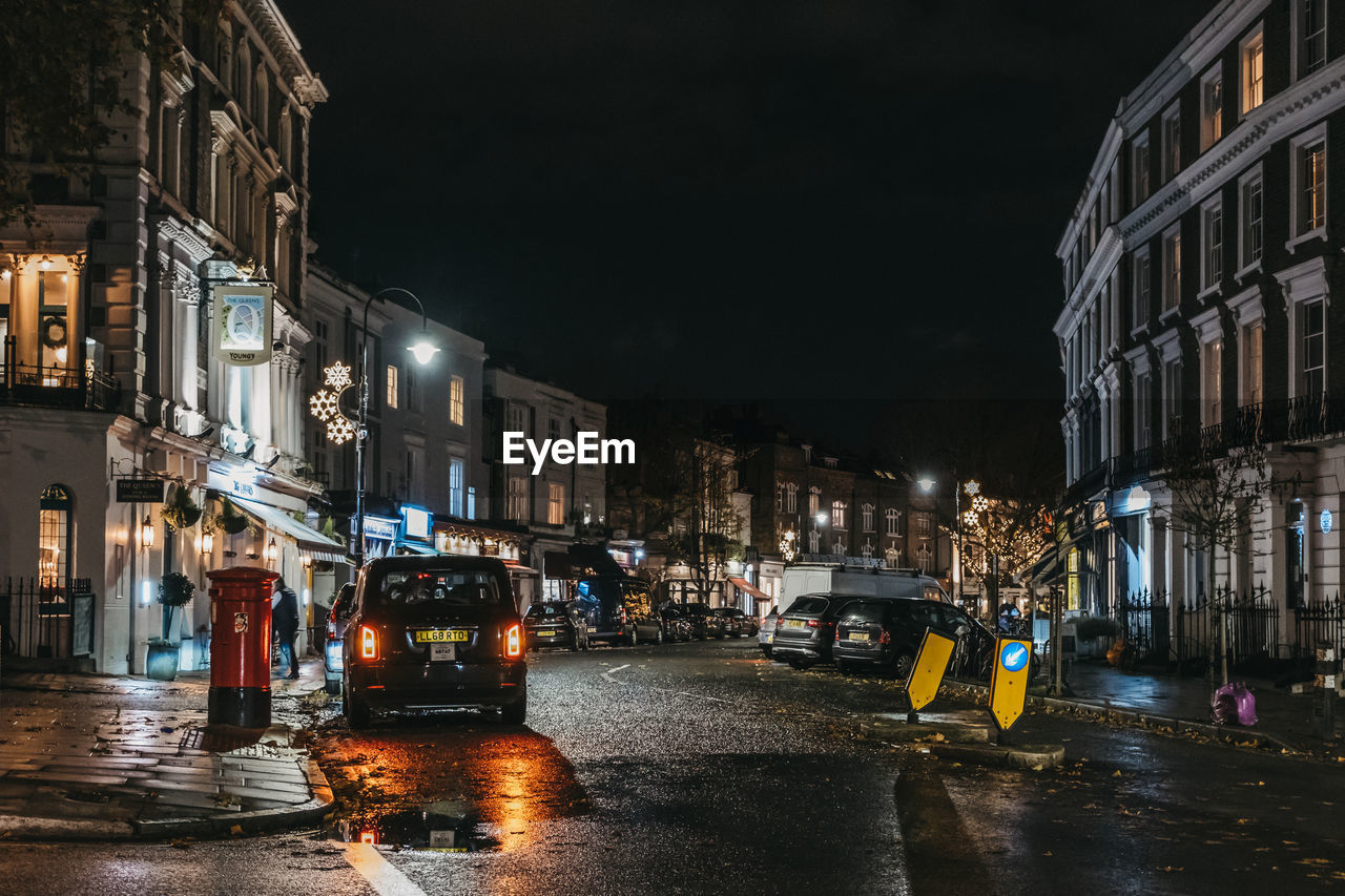 CITY STREET AT NIGHT DURING RAINY SEASON