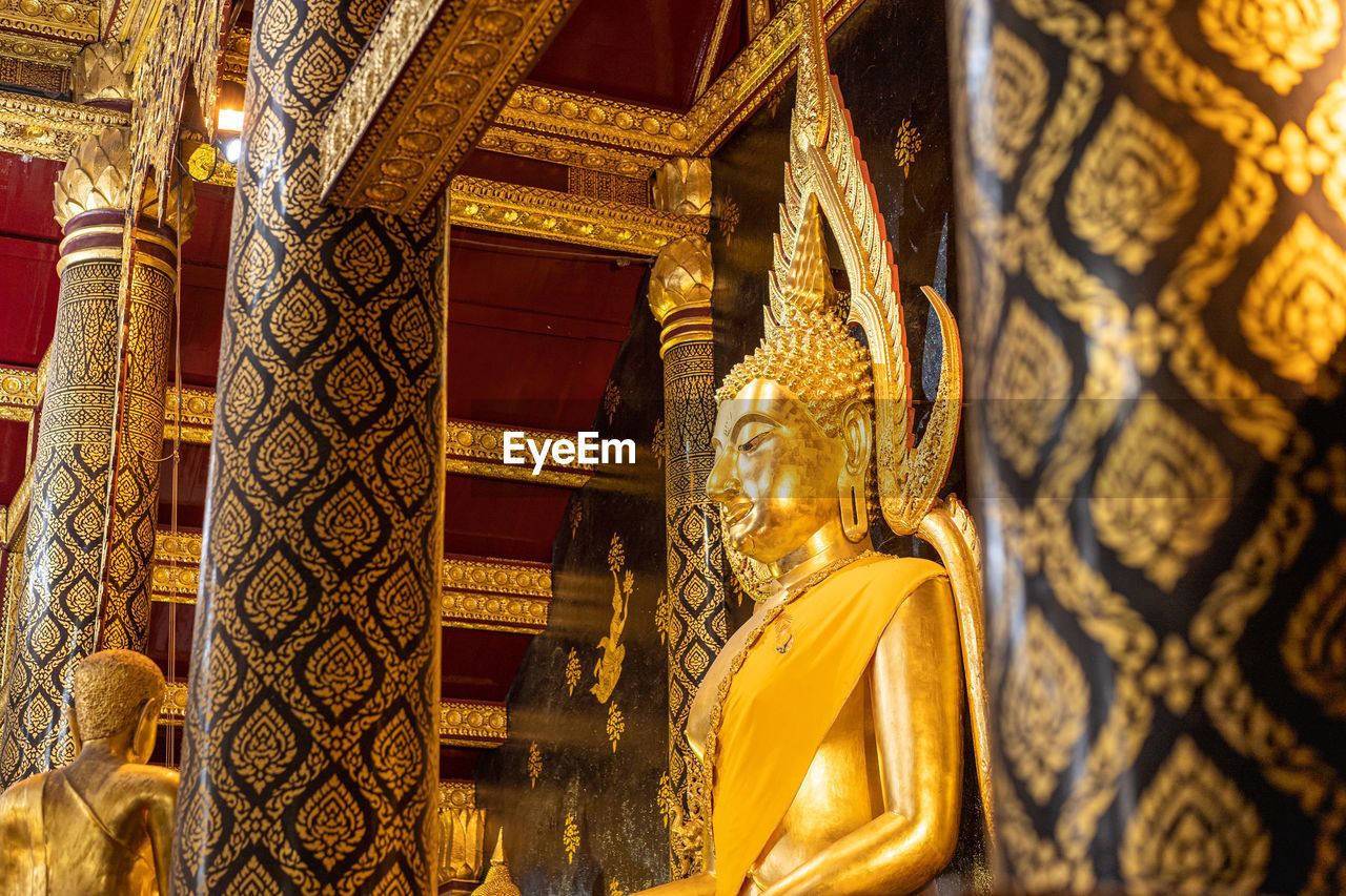 LOW ANGLE VIEW OF STATUE AGAINST BUILDING AT TEMPLE