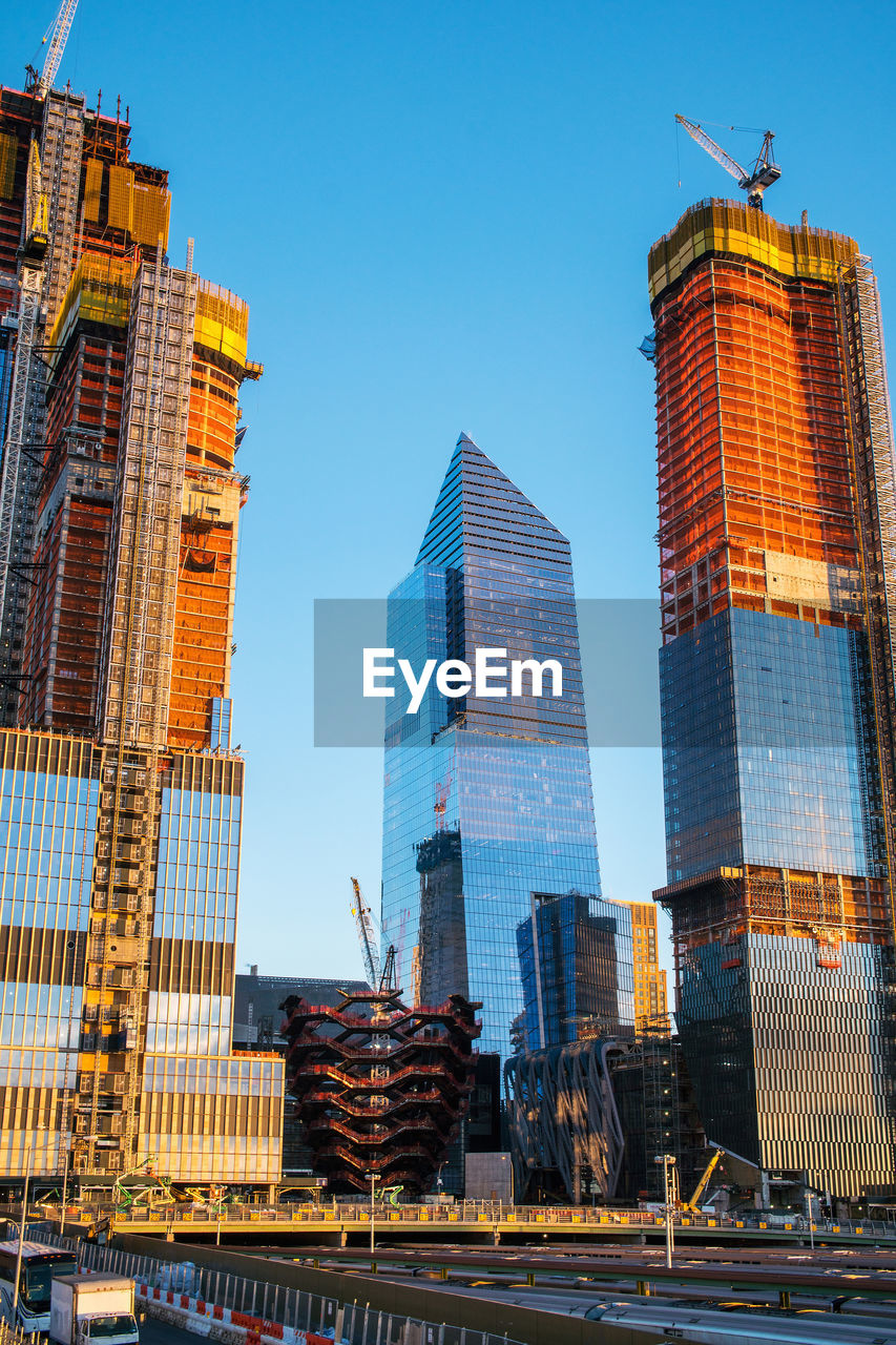 Low angle view of skyscrapers against clear blue sky