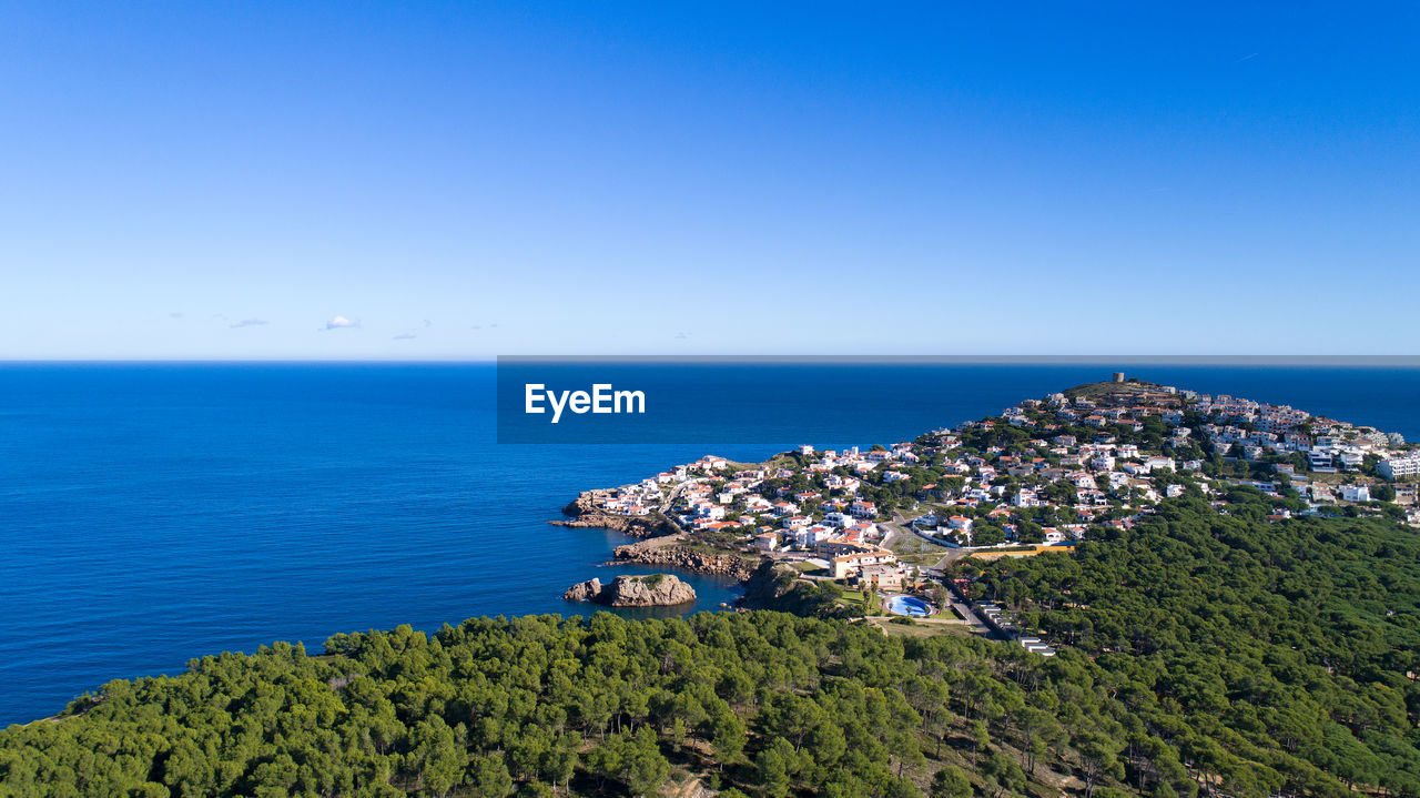 Scenic view of sea against clear blue sky