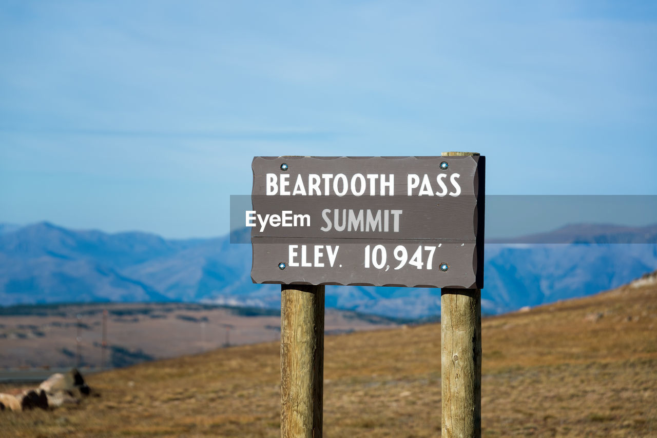 Close-up of information sign on landscape