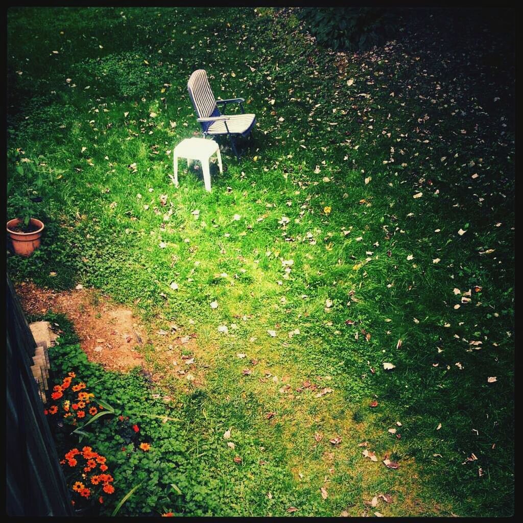 High angle view of chairs on grassy field