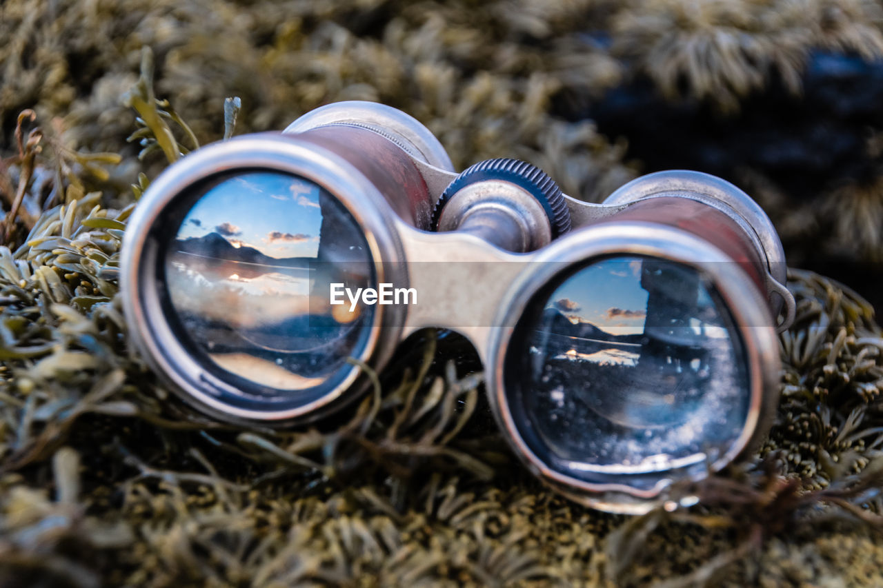 Close-up of binoculars on grass