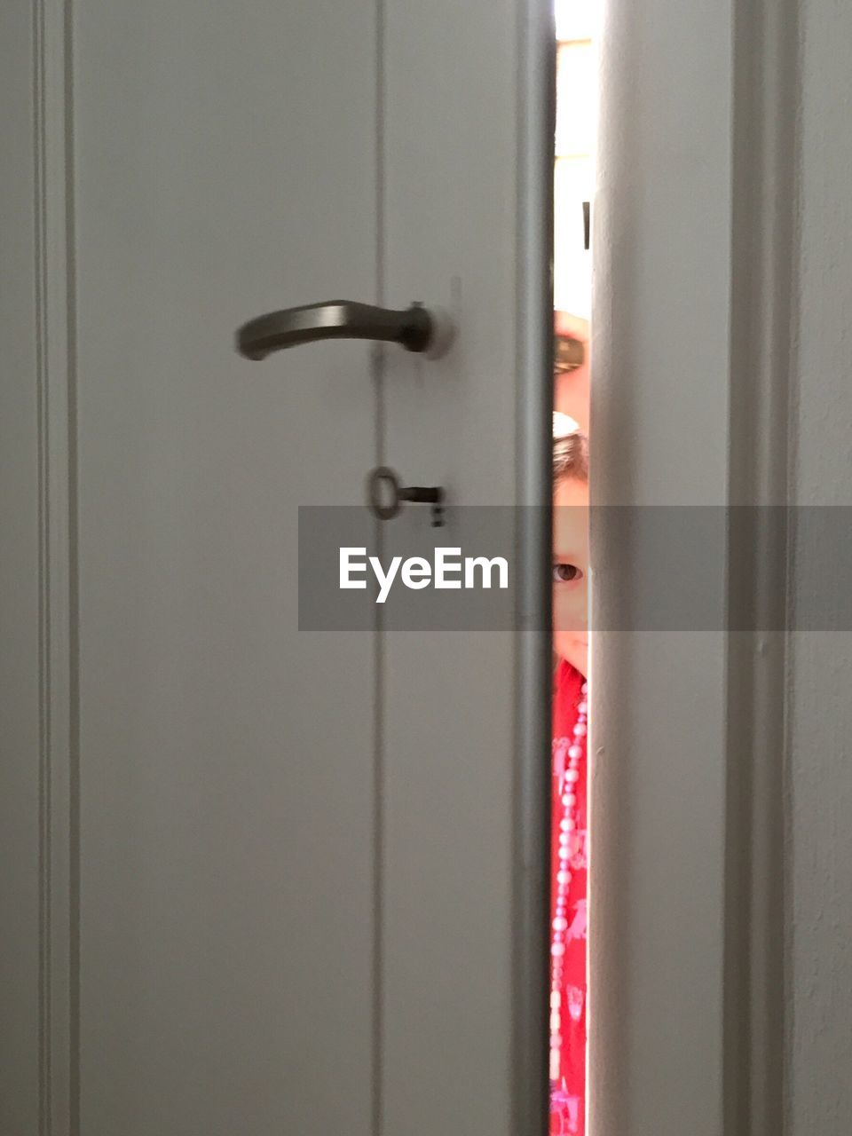 Portrait of girl seen through open door