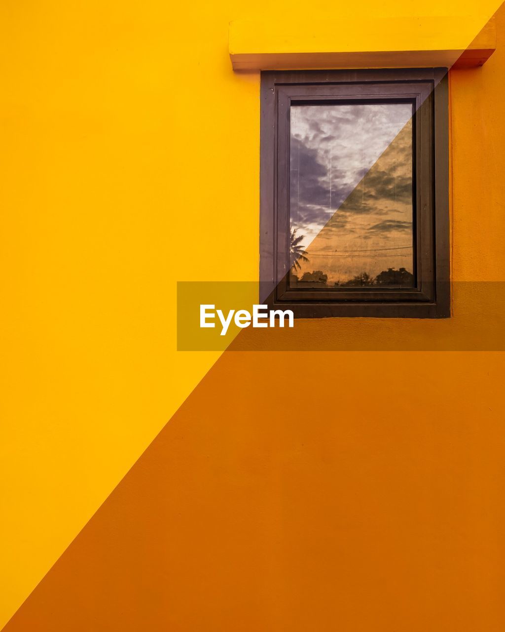 Yellow window of orange building