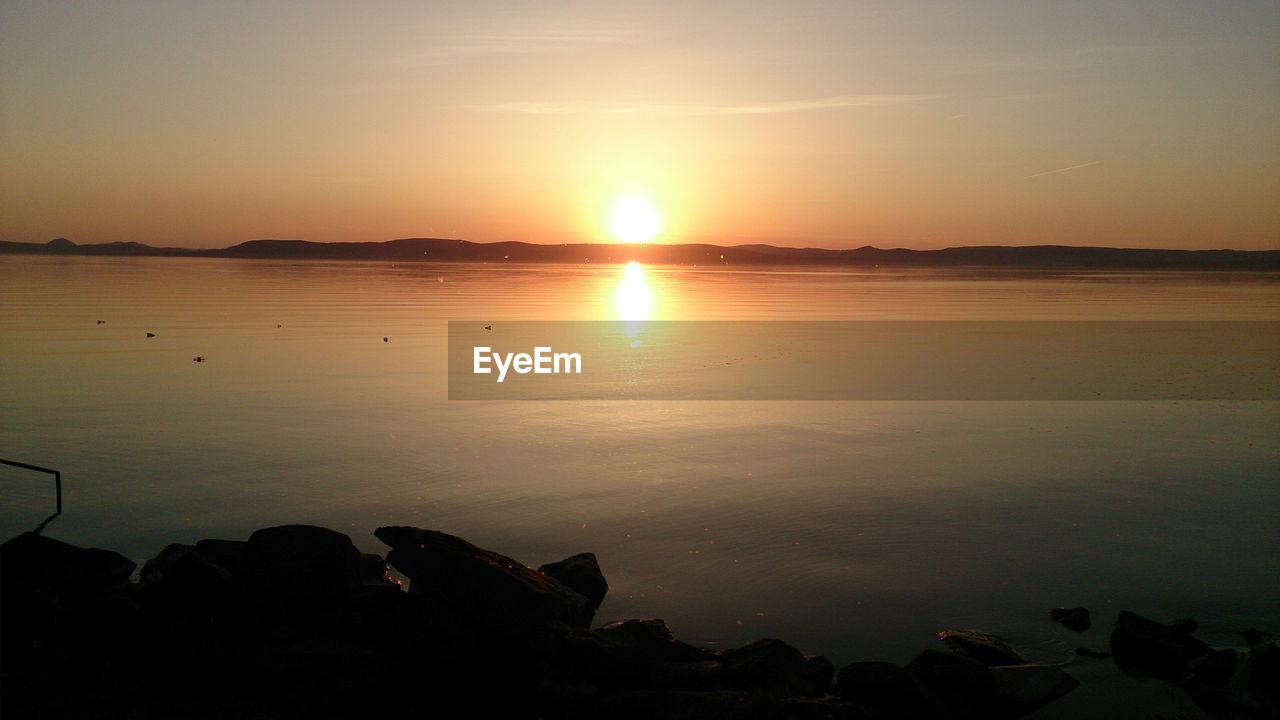 SCENIC VIEW OF SUNSET OVER SEA