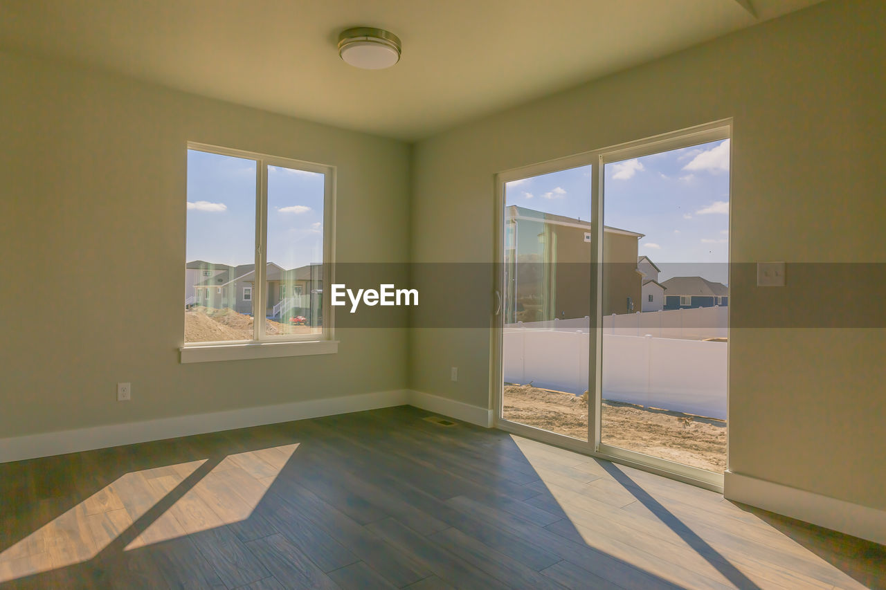 VIEW OF BUILDING THROUGH OPEN WINDOW