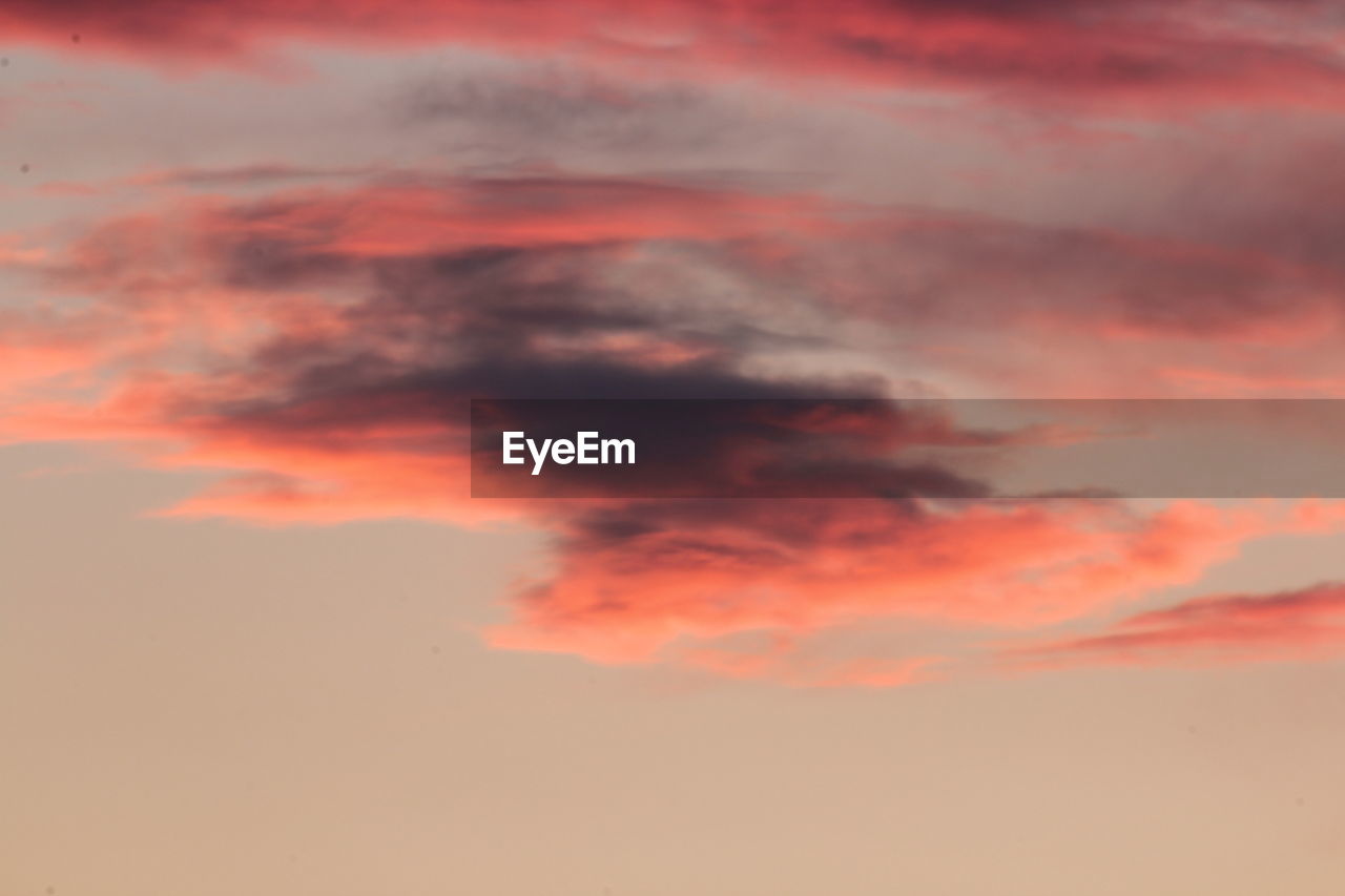 LOW ANGLE VIEW OF ORANGE CLOUDS IN SKY