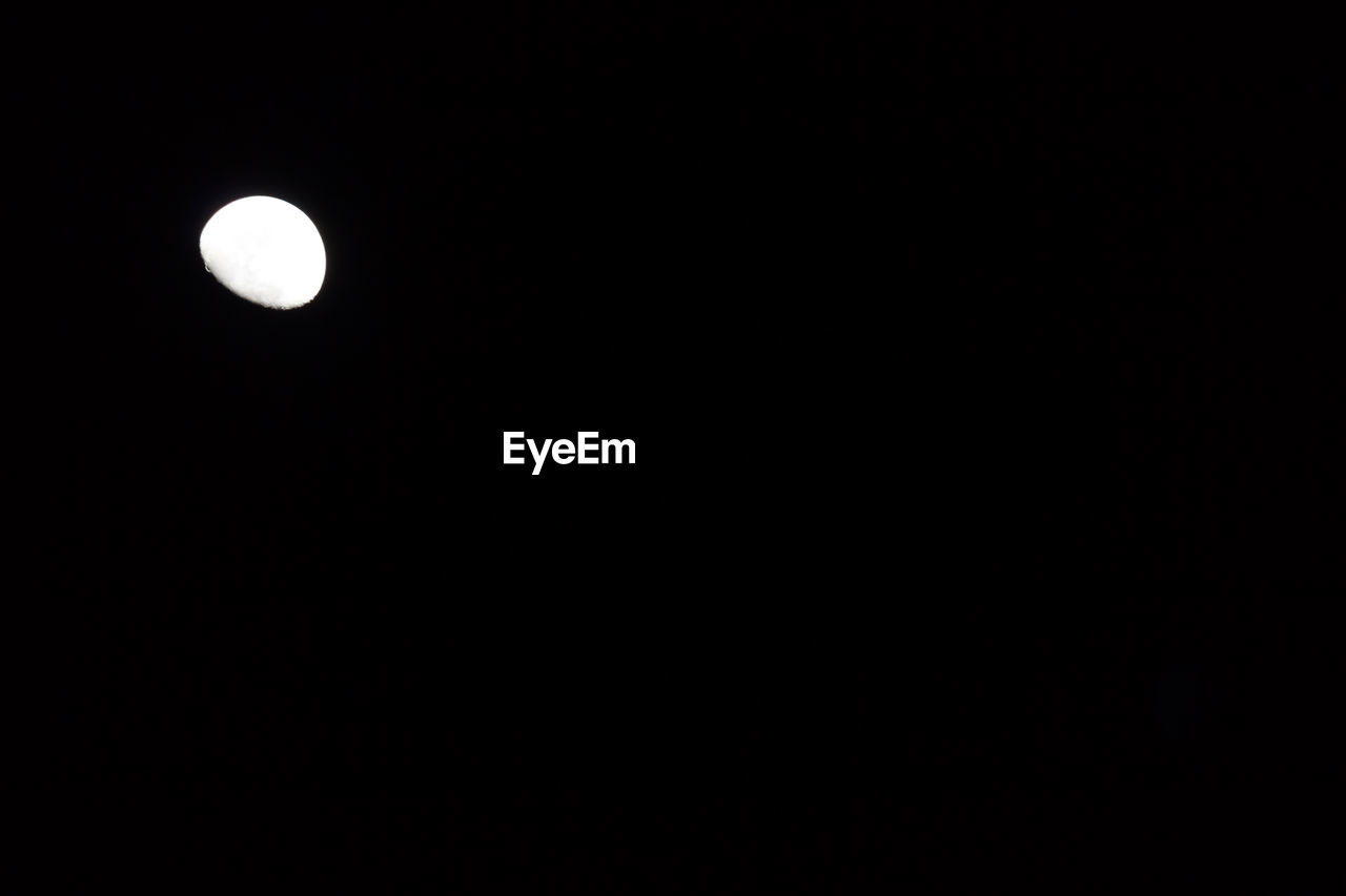 LOW ANGLE VIEW OF MOON IN SKY AT NIGHT