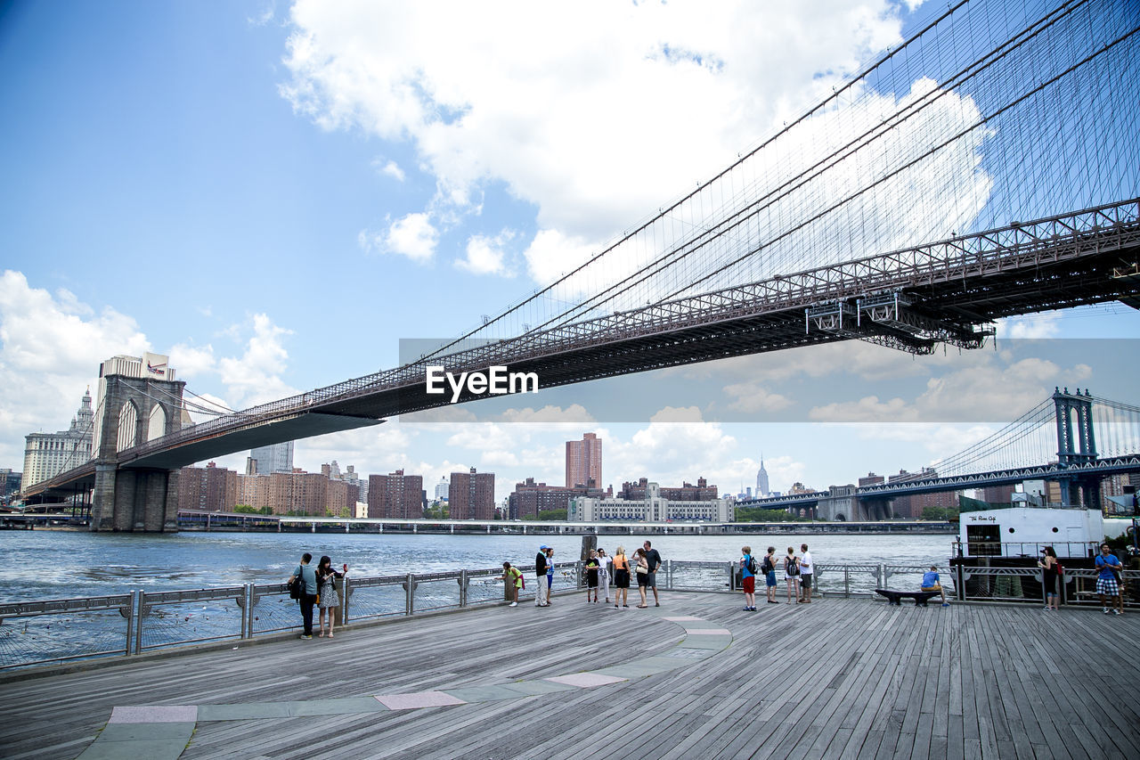 Bridge over river with city in background