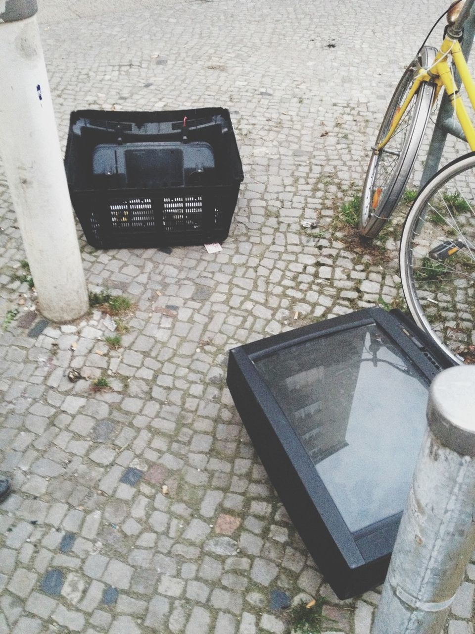 High angle view of television and basket on sidewalk