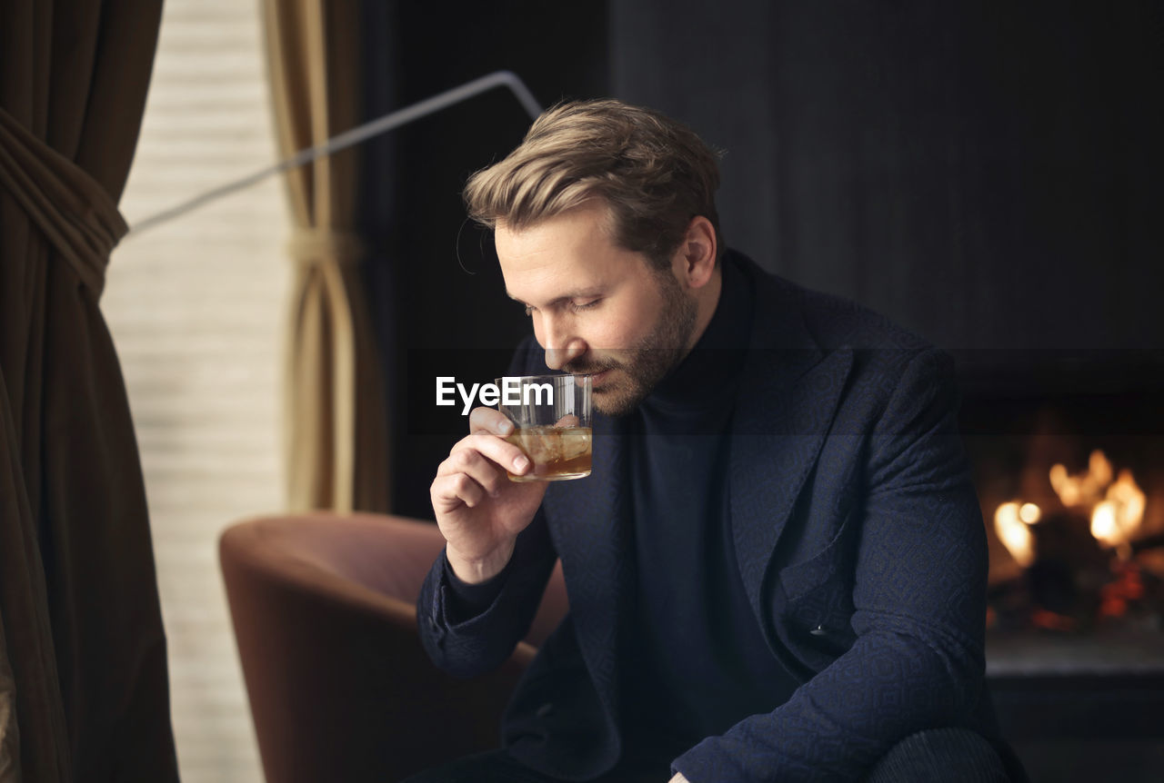 Handsome man drinks a whisky